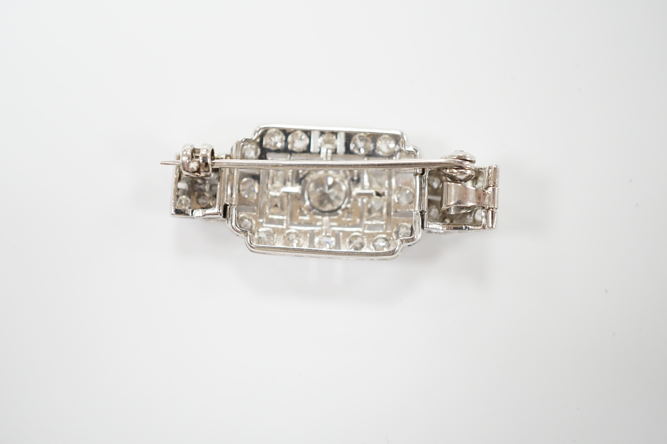 An Art Deco style white metal and diamond cluster set pendant brooch, overall 38mm, gross weight 5.9 grams.